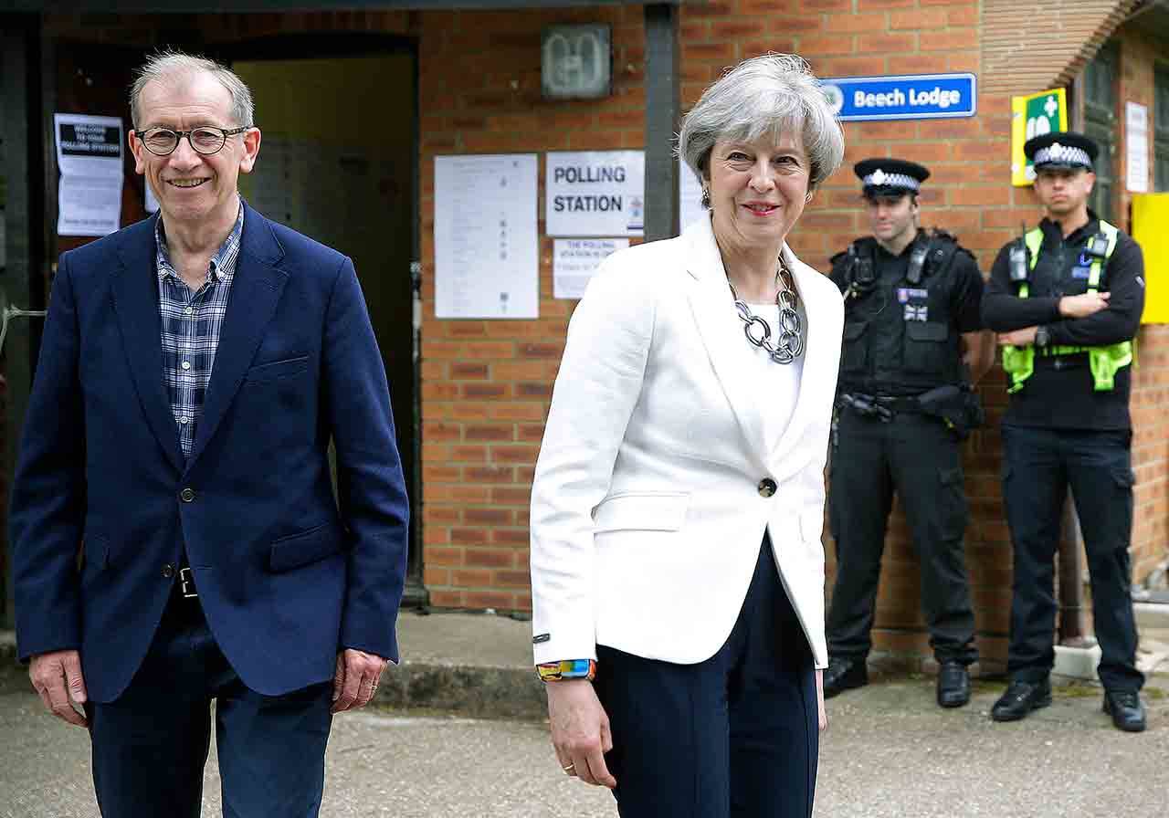 British Prime Minister Theresa May leaves with her husband, Philip, after voting in the general election at a polling station in Maidenhead, England, on Thursday.