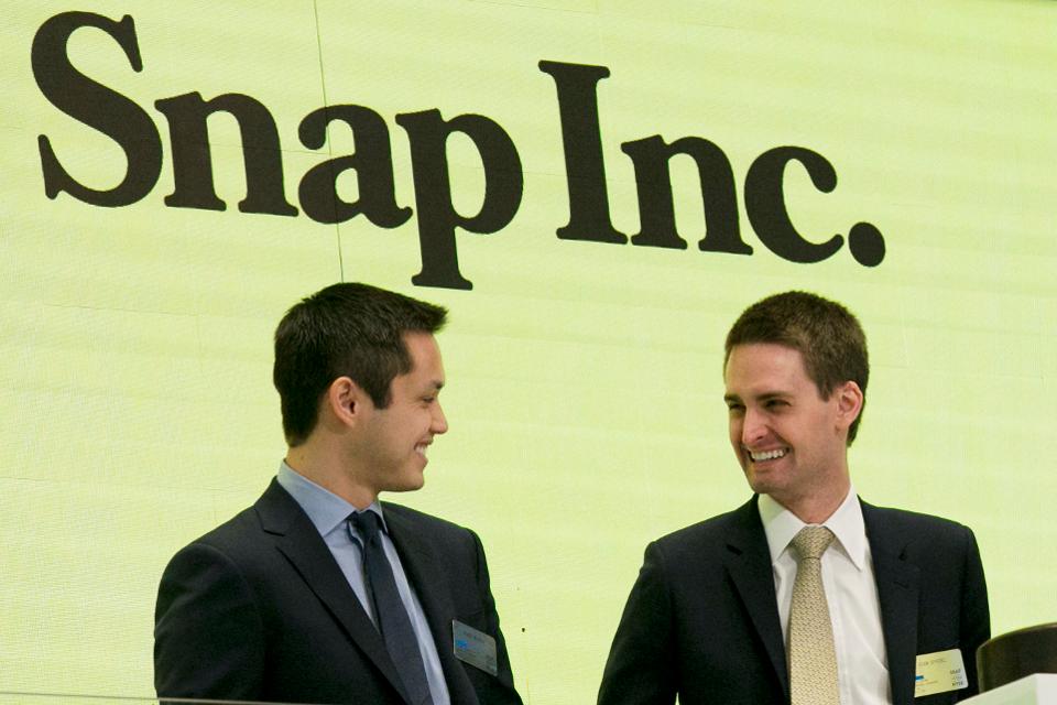 Snap co-founders Bobby Murphy, left, and CEO Evan Spiegel ring the opening bell at the New York Stock Exchange as the company celebrates its IPO.