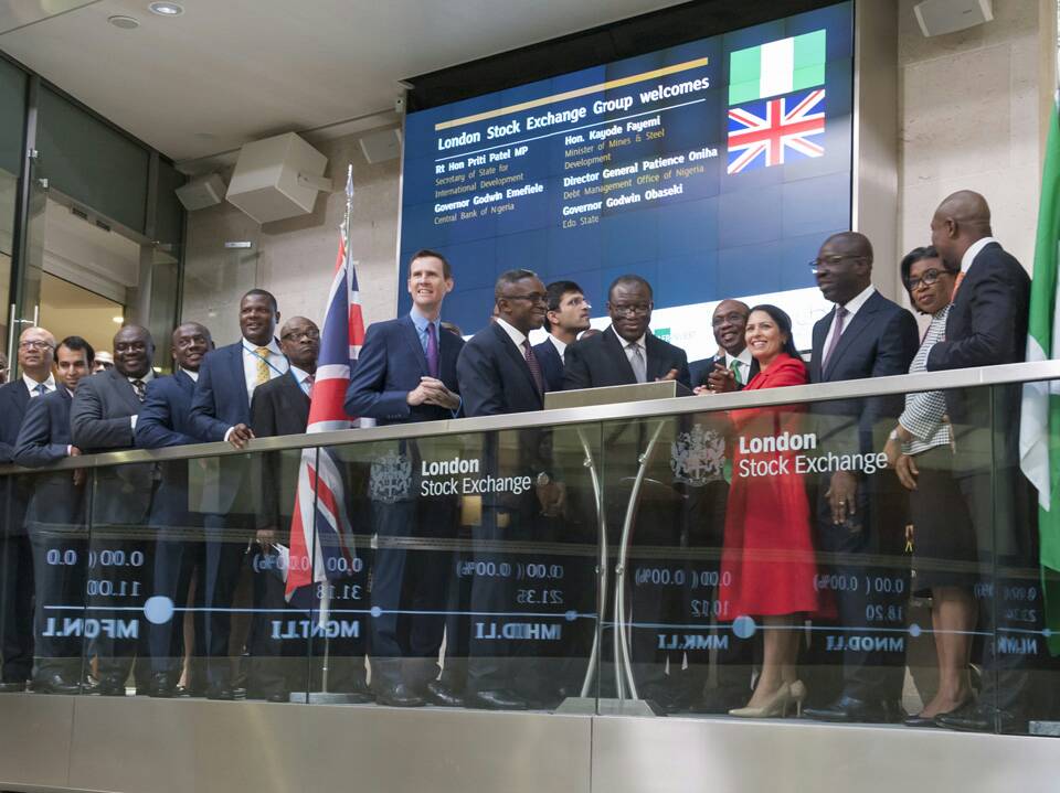 Nigeria's central bank governor, Godwin Emefiele, surrounded by officials, analysts and investors, rings the opening bell, Friday 27th October, 2017 at the London Stock Exchange in the United Kingdom