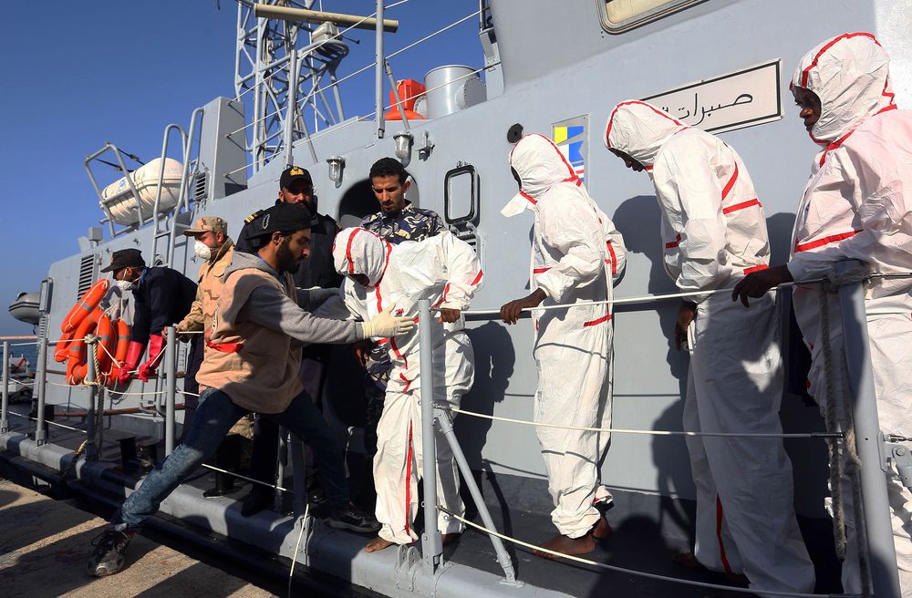 African migrants arrive at a naval base in Tripoli on Nov. 25