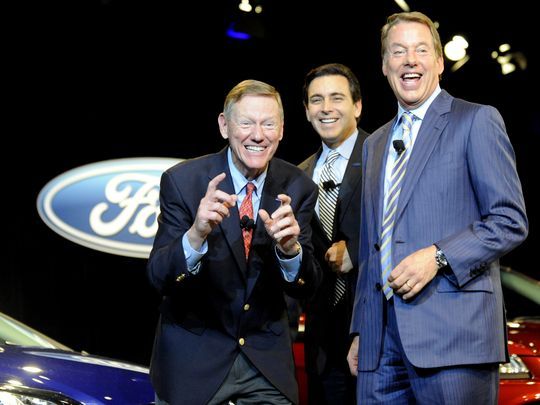 Retiring Ford Motor CEO Alan Mulally makes a picture-taking gesture while clowning around with the company's new CEO Mark Fields, center, and Ford executive chairman Bill Ford Jr. at the Ford World Headquarters in Dearborn on May 1. (Photo: David Coates / The Detroit News)