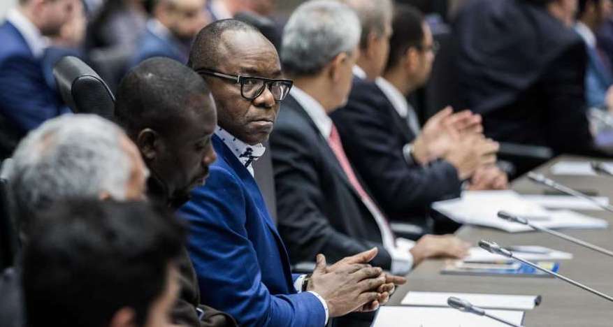 Emmanuel Ibe Kachikwu, Nigeria's petroleum and resources minister, center, looks on during a news conference the 173rd Organization of Petroleum Exporting Countries (OPEC) meeting in Vienna, Austria, on Wednesday, Nov. 29, 2017. OPEC and Russia are said to have agreed they should extend oil-supply cuts deeper into next year, but Moscow wants clarity on an exit strategy before giving formal consent.