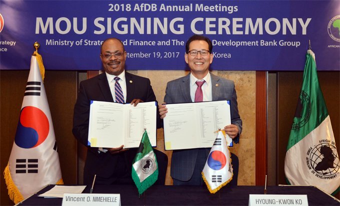 Vincent Nmhielle, secretary-general, and Hyoung-Kwon Ko, Korean Vice Minister of Strategy and Finance, display signed MOU.