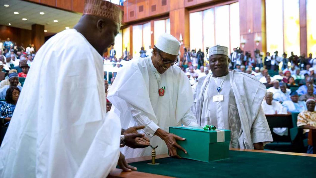 President Muhammadu Buhari (C) presenting copies of the 2017 budget documents to the National Assembly on Wednesday, December 14, 2016