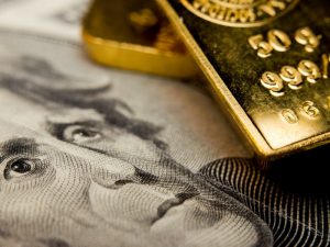 Gold rises over softer dollar as investors await Fed meeting